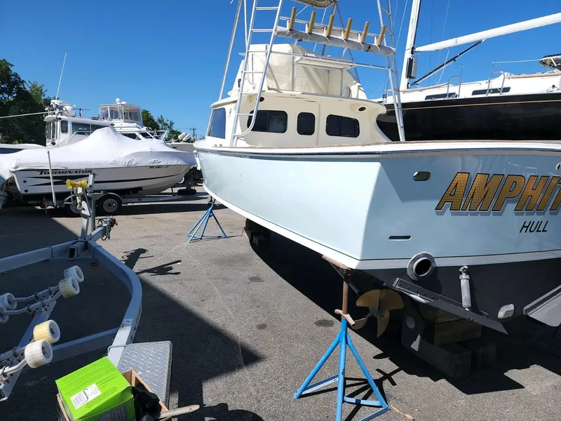 Slide: The Image of 1961 Bertram 31 Flybridge Cruiser on stands in a boatyard. - 25