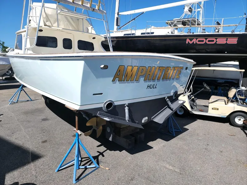 Slide: The Image of 1961 Bertram 31 Flybridge Cruiser on stands, named Amphitrite, in a boatyard. - 26