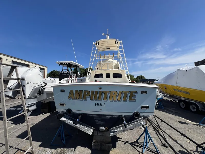 Slide: The Image of 1961 Bertram 31 Flybridge Cruiser "Amphitrite" on dry dock under clear blue sky. - 7