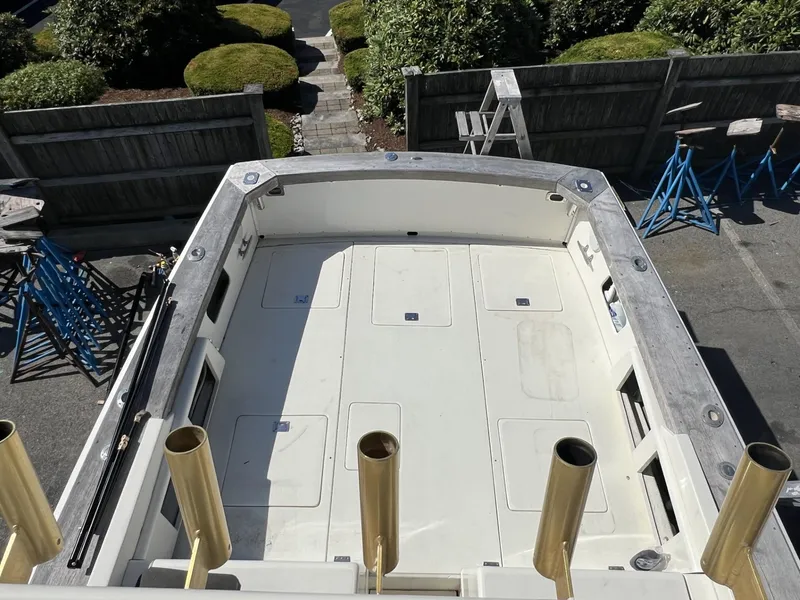 Slide: The Image of 1961 Bertram 31 Flybridge Cruiser deck view, surrounded by maintenance equipment. - 9