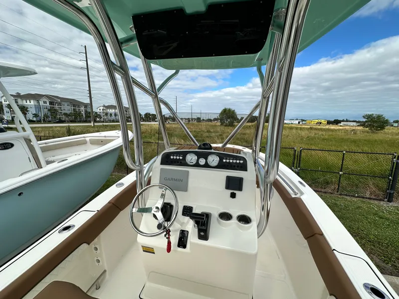 Slide: The Image of 2025 Pioneer 202 Sportfish boat interior with steering console and gauges. - 4