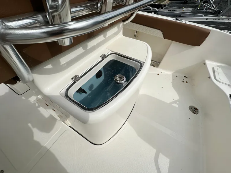 Slide: The Image of 2025 Pioneer 202 Sportfish boat interior with livewell and stainless steel fittings. - 9