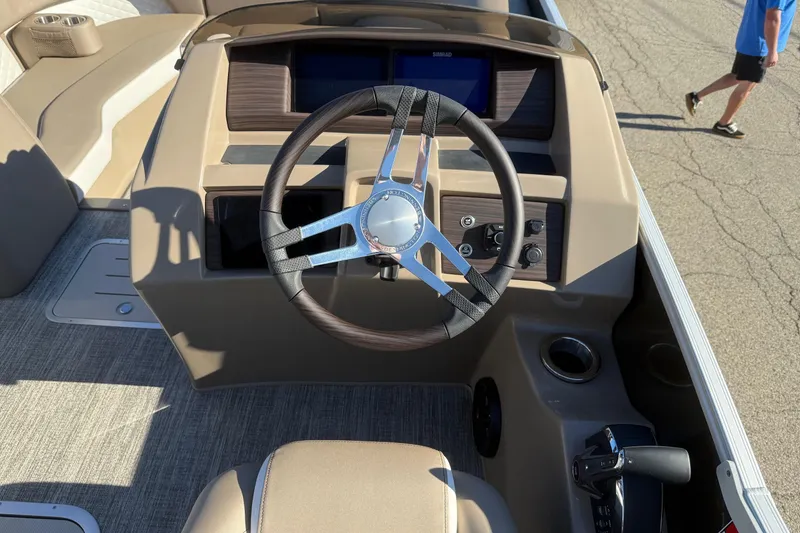Slide: The Image of 2025 Bennington L Bowrider Line boat dashboard with steering wheel and controls. - 13