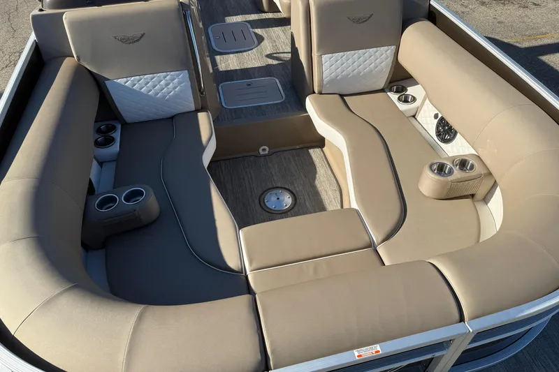 Slide: The Image of 2025 Bennington L Bowrider Line interior with beige seating and cup holders. - 6
