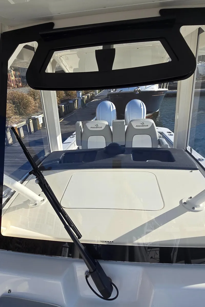 Slide: The Image of 2021 Regulator 34 Center Console boat interior with dual seats and windshield view. - 13