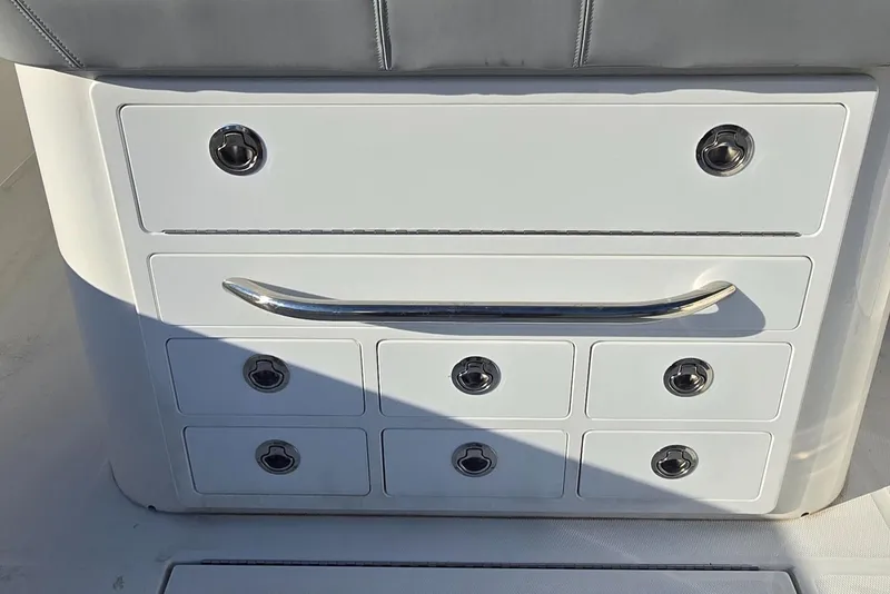 Slide: The Image of 2021 Regulator 34 Center Console storage drawers with stainless steel handles. - 15