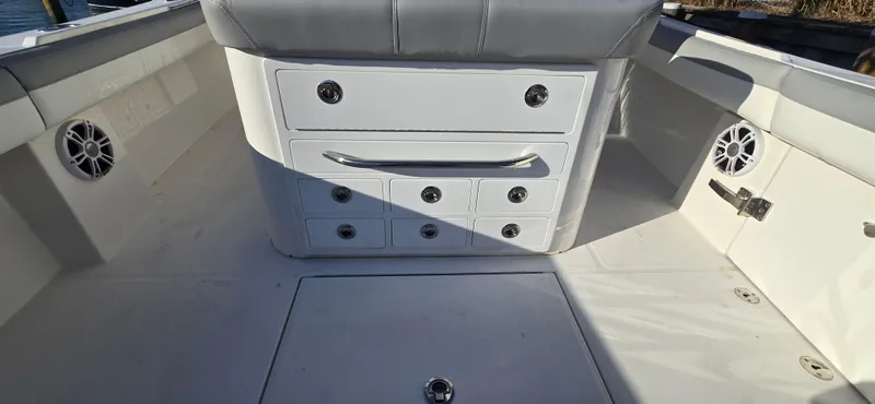 Slide: The Image of 2021 Regulator 34 Center Console boat interior with storage compartments and speakers. - 16