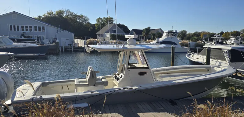 Slide: The Image of 2021 Regulator 34 Center Console boat docked in a marina. - 18