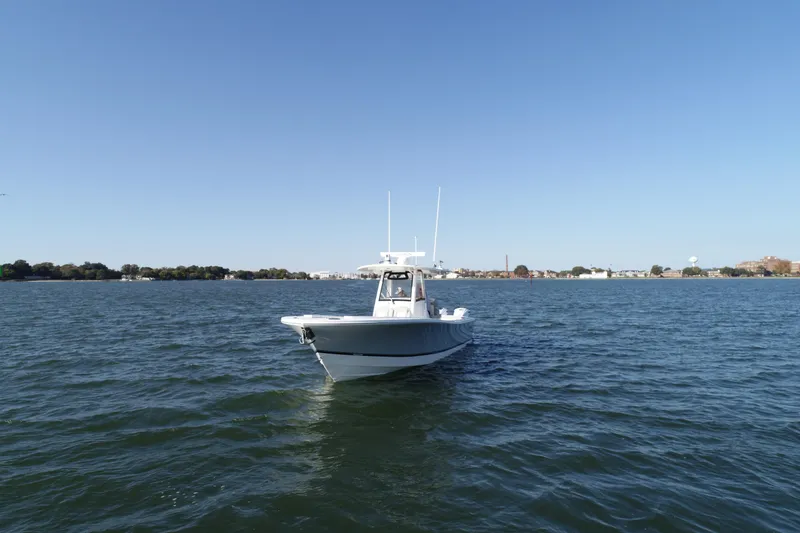 Slide: The Image of 2021 Regulator 34 Center Console boat on open water under clear blue sky. - 23