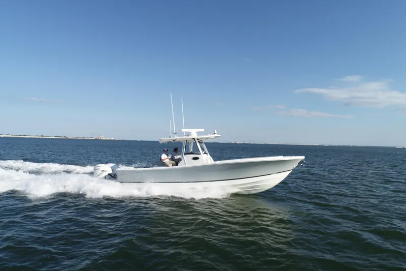 Slide: The Image of 2021 Regulator 34 Center Console boat cruising on open water. - 25