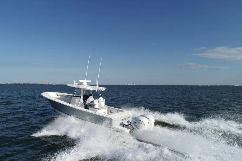 Slide: The Image of 2021 Regulator 34 Center Console boat cruising on open water. - 26