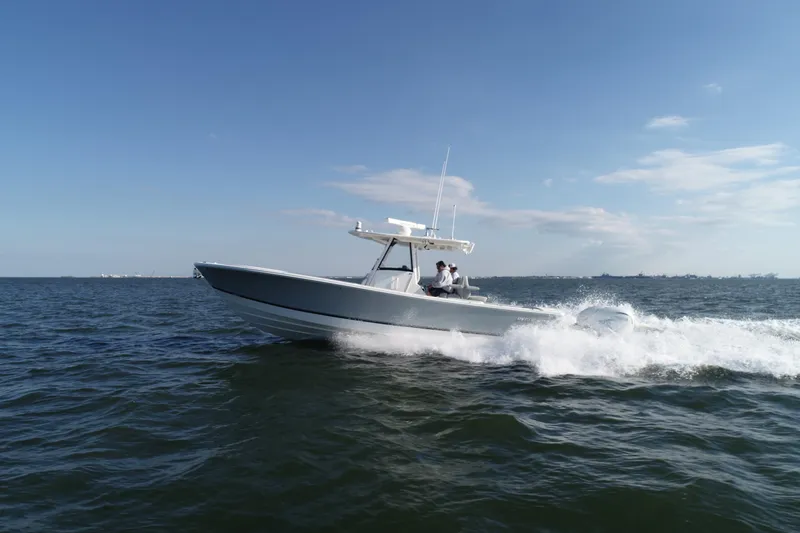 Slide: The Image of 2021 Regulator 34 Center Console boat cruising on open water. - 27