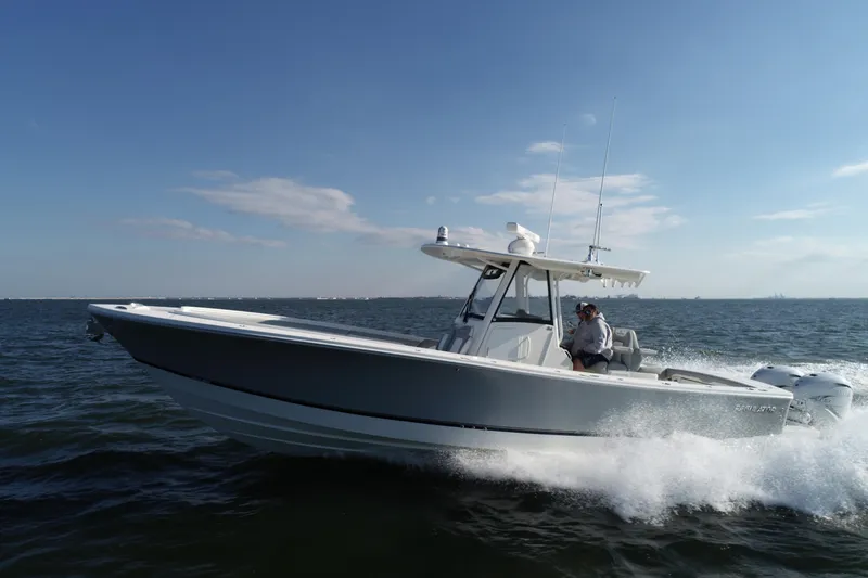 Slide: The Image of 2021 Regulator 34 Center Console boat cruising on open water. - 28