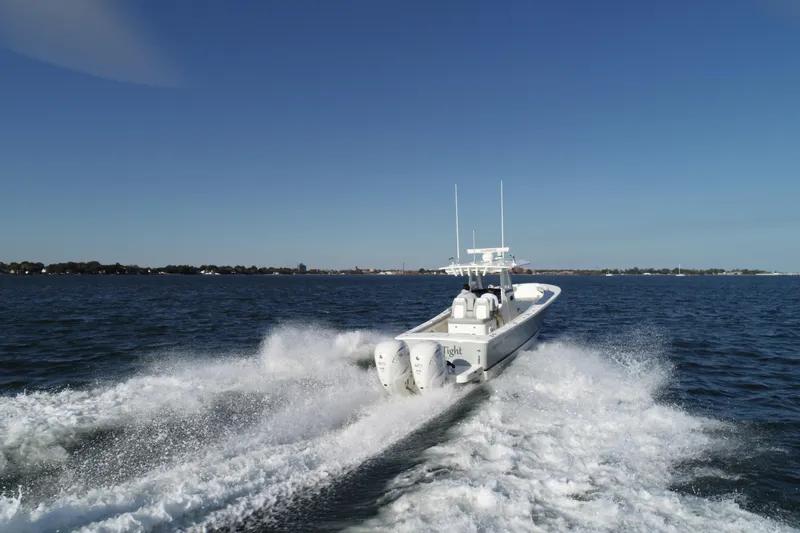 Slide: The Image of 2021 Regulator 34 Center Console boat cruising on open water. - 29