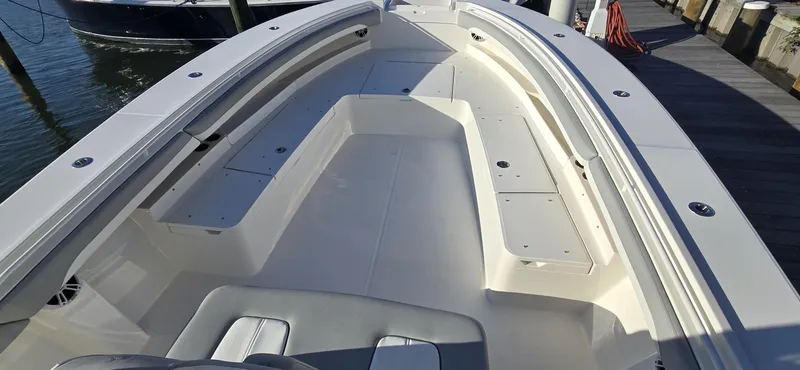Slide: The Image of 2021 Regulator 34 Center Console boat interior, spacious seating, docked at marina. - 3