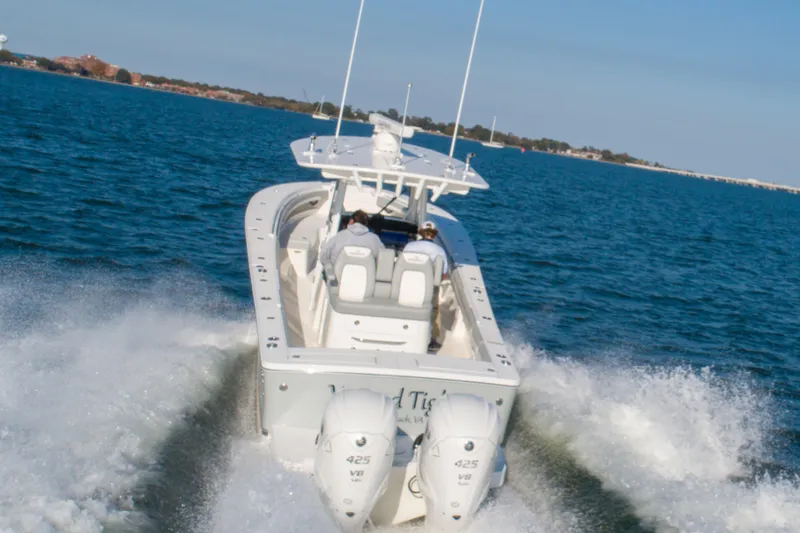 Slide: The Image of 2021 Regulator 34 Center Console boat cruising on open water. - 30