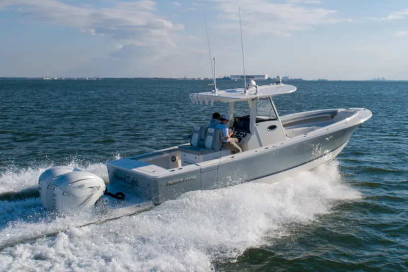 Slide: The Image of 2021 Regulator 34 Center Console boat cruising on open water. - 31