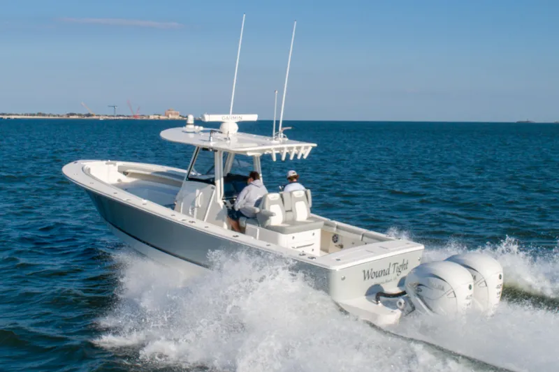 Slide: The Image of 2021 Regulator 34 Center Console boat cruising on open water. - 32