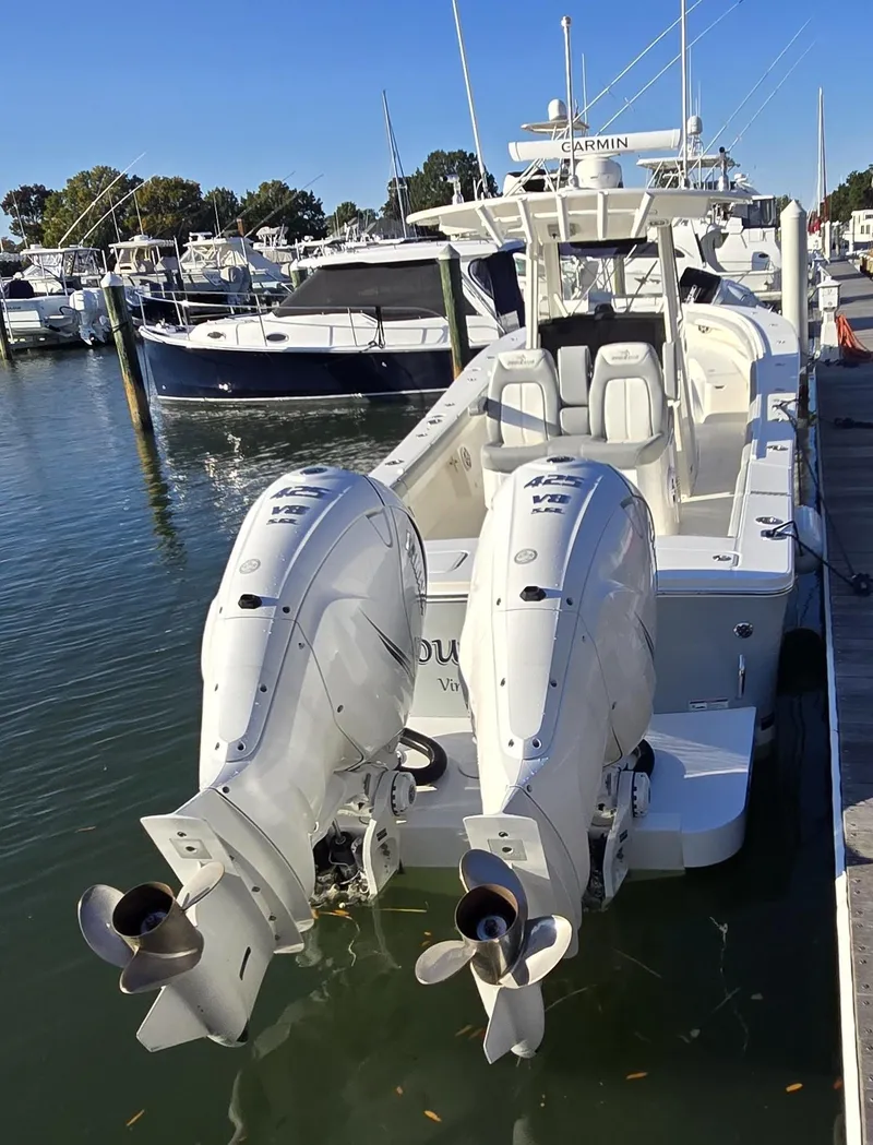 Slide: The Image of 2021 Regulator 34 Center Console boat docked with twin outboard engines. - 33