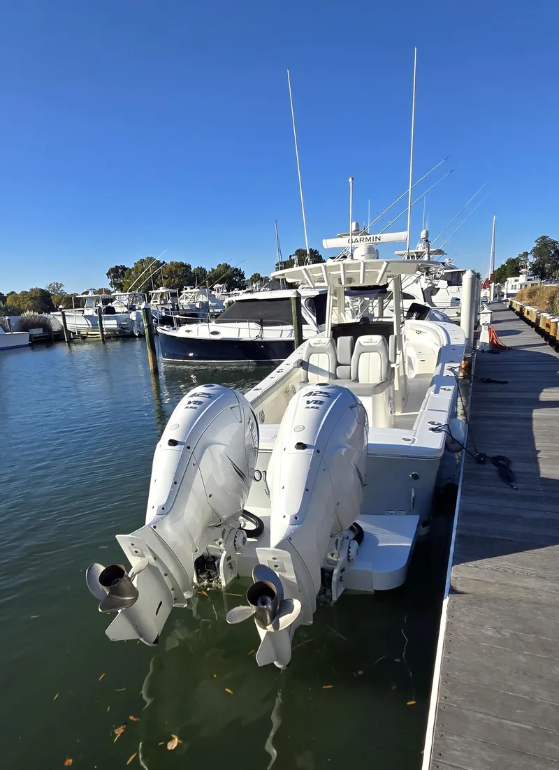 Slide: The Image of 2021 Regulator 34 Center Console boat docked with dual outboard engines. - 34