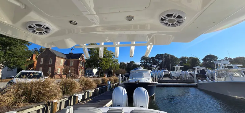 Slide: The Image of 2021 Regulator 34 Center Console docked at a marina with clear blue skies. - 35