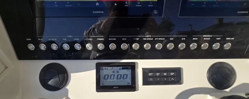 Slide: The Image of 2021 Regulator 34 Center Console dashboard with Garmin displays and control buttons. - 8
