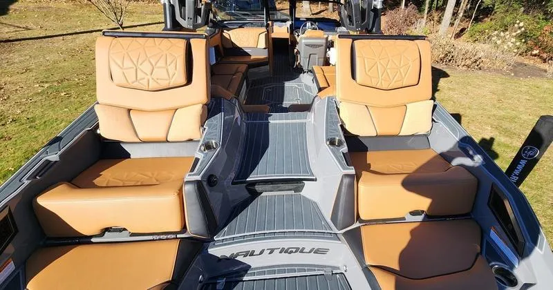 Slide: The Image of Interior of 2022 Nautique G25 Paragon boat with tan seating and sleek design. - 13