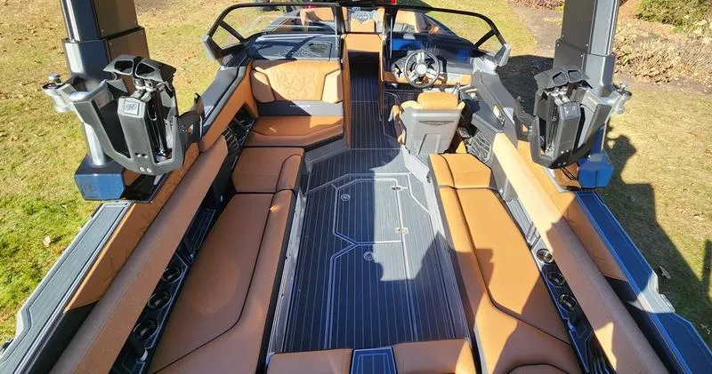 Slide: The Image of 2022 Nautique G25 Paragon interior with luxurious seating and advanced controls. - 15