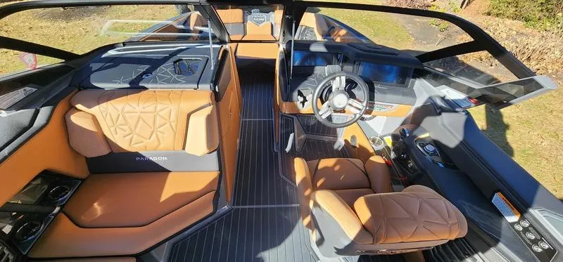 Slide: The Image of Luxurious interior of 2022 Nautique G25 Paragon boat with tan leather seating. - 17