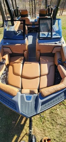 Slide: The Image of 2022 Nautique G25 Paragon boat with luxurious tan seating and sleek design. - 18