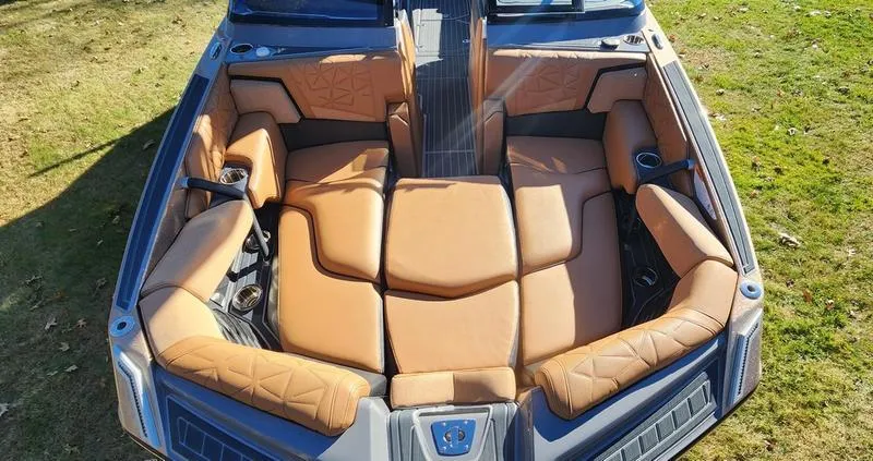 Slide: The Image of 2022 Nautique G25 Paragon boat interior with tan leather seating. - 19
