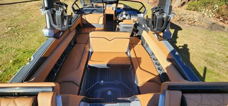 Slide: The Image of 2022 Nautique G25 Paragon interior with luxurious tan seating and sleek design. - 22