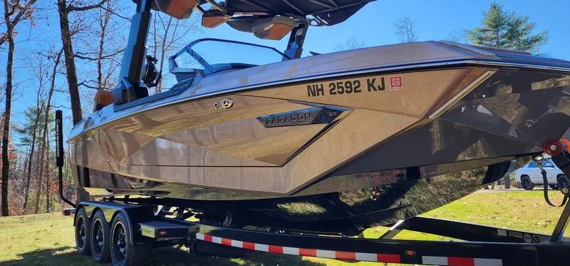 Slide: The Image of 2022 Nautique G25 Paragon boat on trailer, parked outdoors. - 27