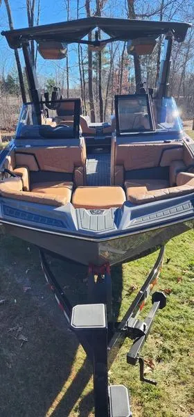 Slide: The Image of 2022 Nautique G25 Paragon boat with luxurious seating, displayed outdoors. - 28