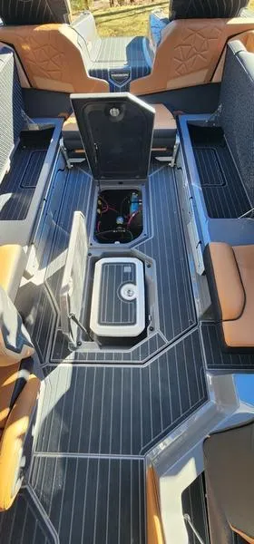 Slide: The Image of 2022 Nautique G25 Paragon interior with open storage compartments and luxurious seating. - 32