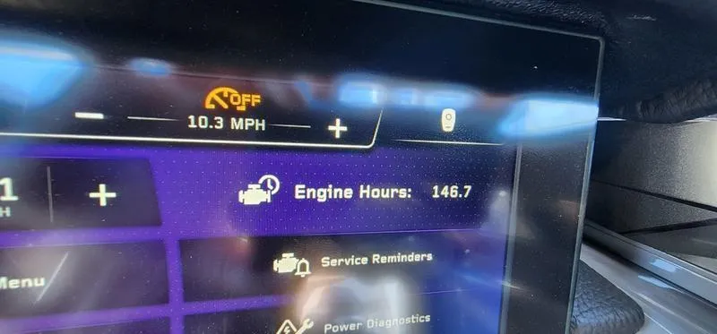 Slide: The Image of 2022 Nautique G25 Paragon dashboard showing 146.7 engine hours and 10.3 MPH speed. - 34