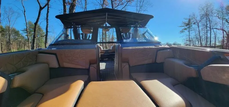 Slide: The Image of 2022 Nautique G25 Paragon boat interior with luxurious seating and sleek design. - 36