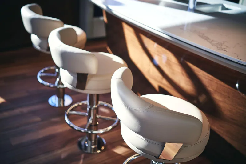 Slide: The Image of Luxurious bar stools on the 2025 Princess X95 yacht interior. - 20