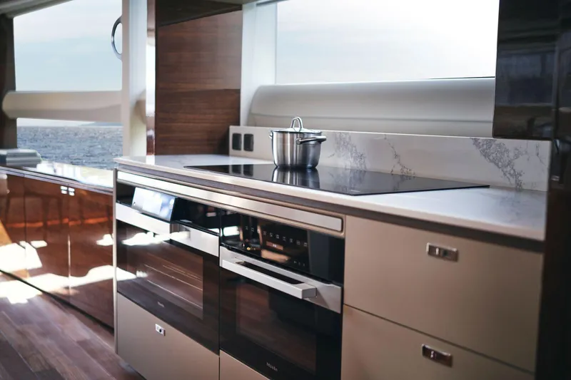 Slide: The Image of Modern kitchen interior on 2025 Princess X95 yacht, featuring sleek appliances and ocean view. - 21