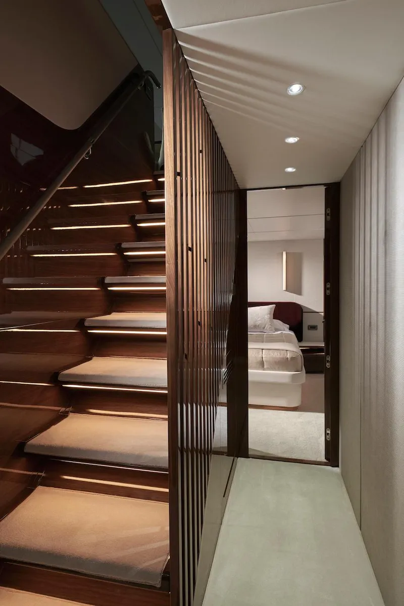 Slide: The Image of Luxurious interior of 2025 Princess X95 yacht, featuring elegant staircase and modern bedroom. - 36
