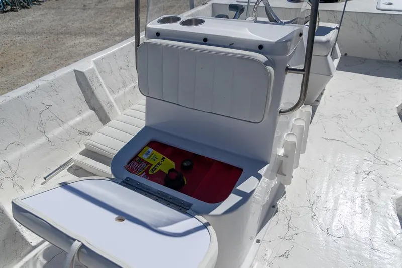 Slide: The Image of 2025 Coastal Skiff 184 boat interior with open storage compartment and seating. - 16