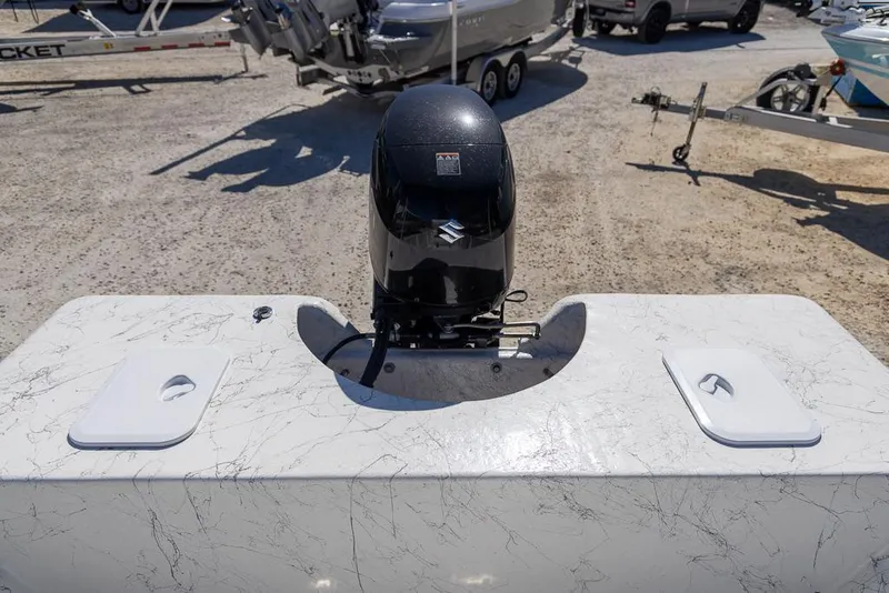 Slide: The Image of 2025 Coastal Skiff 184 boat with outboard motor in a marina setting. - 17