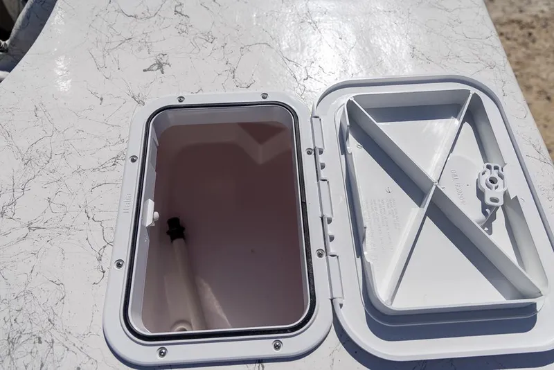 Slide: The Image of Open hatch on 2025 Coastal Skiff 184 boat deck. - 18