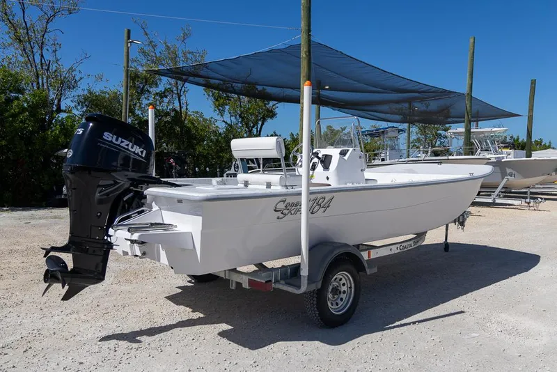 Slide: The Image of 2025 Coastal Skiff 184 boat with Suzuki outboard motor on trailer. - 2