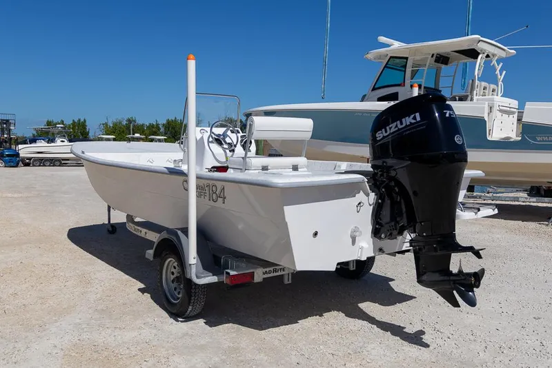 Slide: The Image of 2025 Coastal Skiff 184 boat with Suzuki outboard motor on trailer. - 4