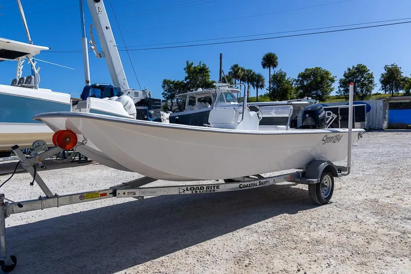 Slide: The Image of 2025 Coastal Skiff 184 boat on trailer in sunny outdoor setting. - 6