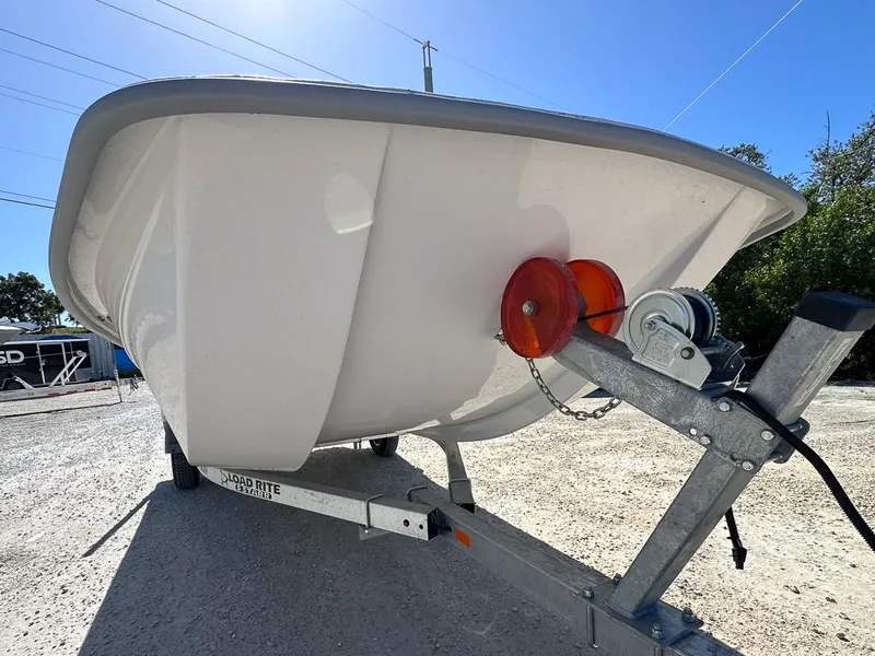 Slide: The Image of 2025 Coastal Skiff 184 boat on trailer, sunny day, close-up view. - 8