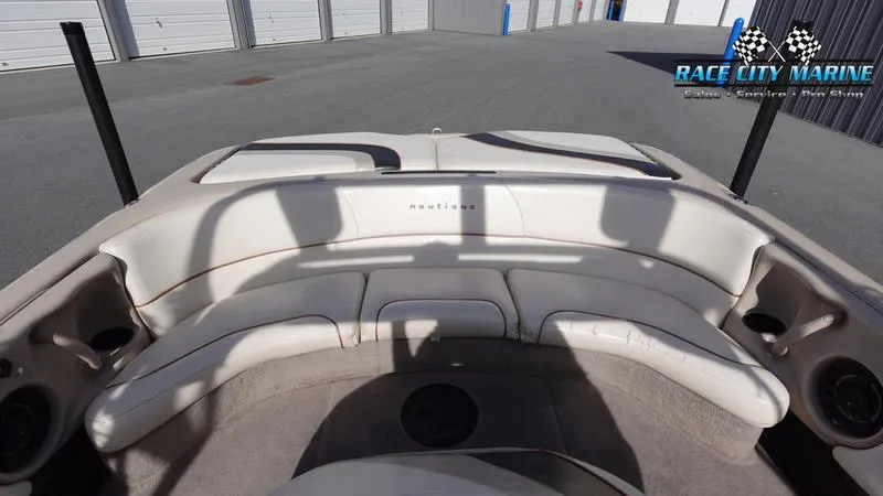 Slide: The Image of 2003 Nautique Air Nautique 216 boat interior with white seating, Race City Marine logo. - 12