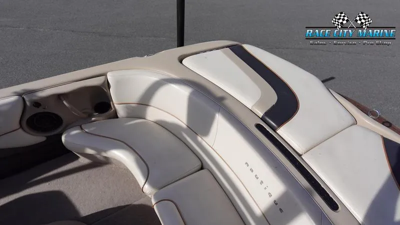 Slide: The Image of 2003 Nautique Air Nautique 216 boat interior with beige seating and Race City Marine logo. - 13