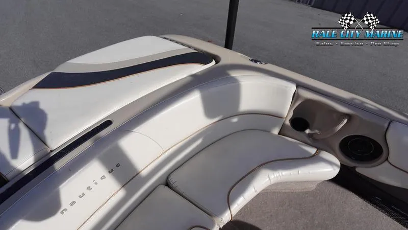 Slide: The Image of 2003 Nautique Air Nautique 216 boat interior with white seating and Race City Marine logo. - 14